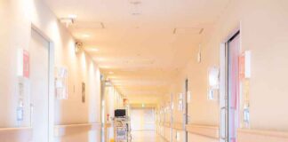 Hospital corridor with doors and medical cart