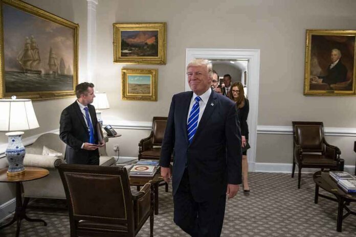 shutterstock_1456093772 Donald Trump walks through an office with Sean Lawler nearby and Mariano Rajoy following behind