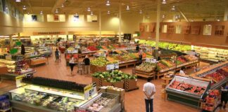 Interior of a grocery store filled with fresh produce and shoppers