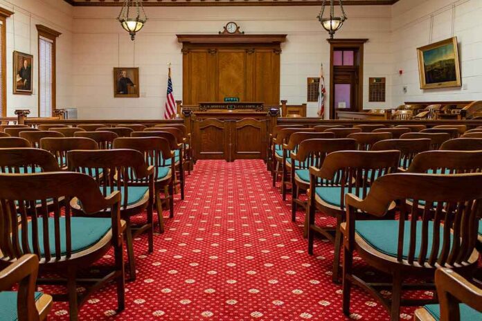 Courtroom with wooden benches facing the judge's bench