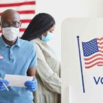 Voters wearing masks at a polling station