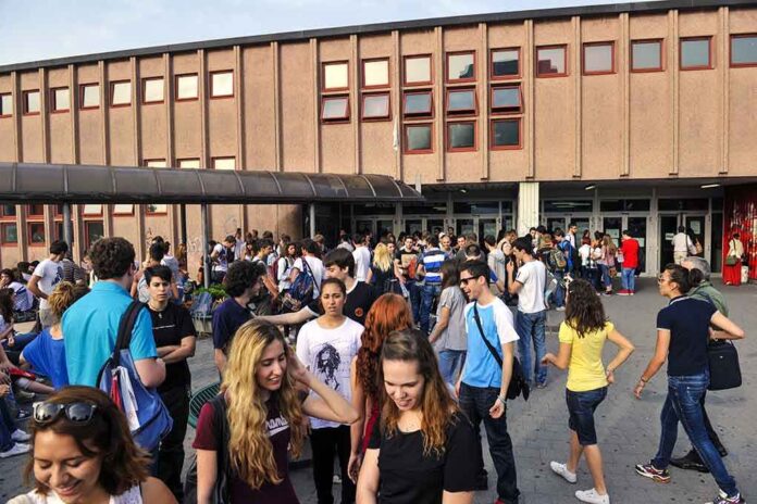 shutterstock_181110272-1 Students gathered outside a school building entrance