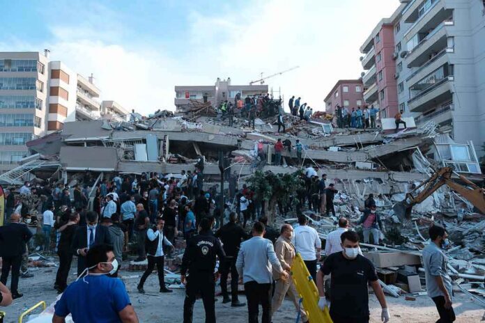 shutterstock_1845063010-1 Rescue workers and civilians on collapsed building after earthquake