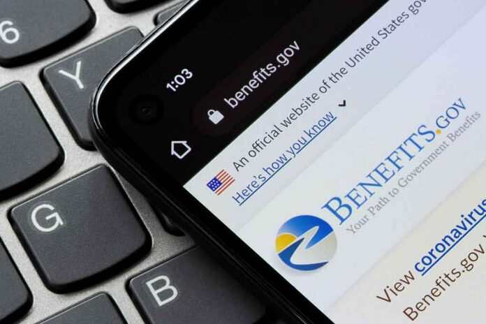 shutterstock_2084796073 smartphone showing Benefits.gov website on a laptop keyboard