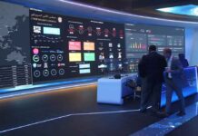 OpenAI Says It Engaged With US Government Websites cybersecurity operations room with large data dashboards and people discussing