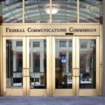 Federal Communications Commission building entrance with gold doors