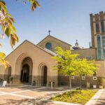 Dem Candidate BRAGS About Harboring Illegals Brick church with arched entrance and tall bell tower on a sunny day