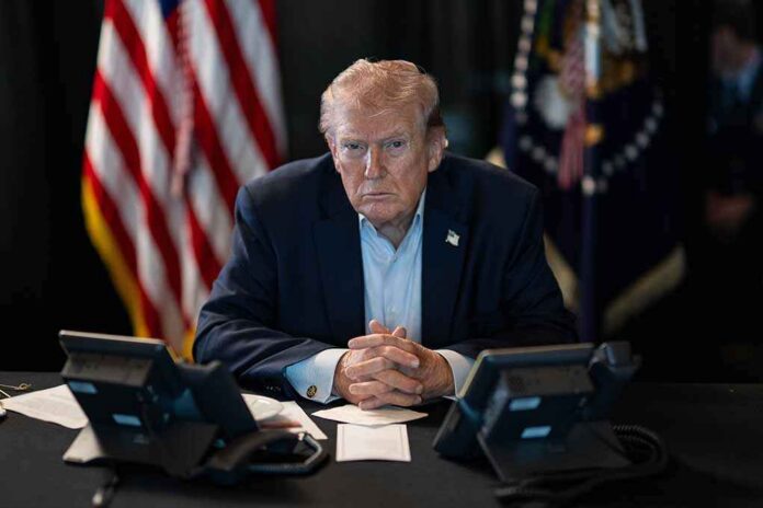President,Donald,J.,Trump,Oversees,Operation,Epic,Fury,At,Mar-a-lago, Person in suit seated at table with telephones