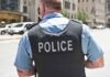 Police officer in uniform from behind on a city street