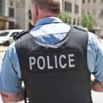 Police officer in uniform from behind on a city street