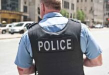 Police officer in uniform from behind on a city street