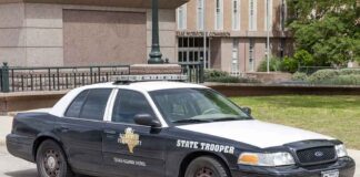 Texas state trooper patrol car parked by a public building