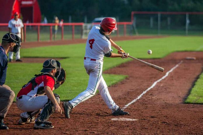 Baseball batter making contact with a pitched ball