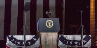 Presidential podium with microphones and teleprompters