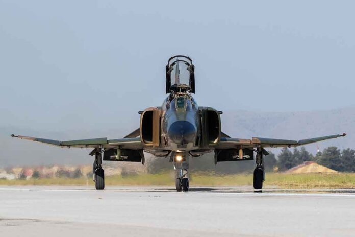 shutterstock_673984819 Military jet taxiing on runway with open canopy
