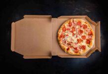 Pepperoni pizza in an open cardboard box