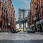 See What the Mob Did to Child Predators in the ’80s Street view with bridge between two brick buildings.