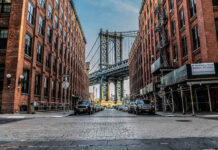 See What the Mob Did to Child Predators in the ’80s Street view with bridge between two brick buildings.