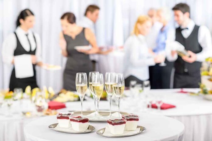 shutterstock_103750646 A table set with champagne glasses and desserts at a social event