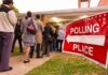 Voters standing in line outside a polling place