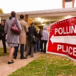 Voters standing in line outside a polling place