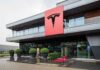 Tesla office building with large red logo sign