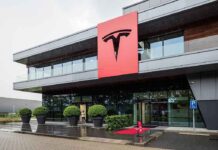 Musk Reveals Austin Mass Shooter Was Fired by Tesla Tesla office building with large red logo sign