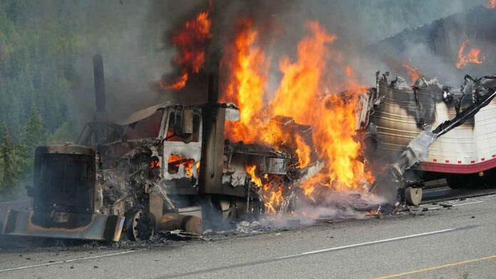 Burning semi-truck cab and trailer on highway