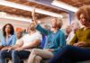 Brian Yorkey in a community meeting as a woman raises her hand