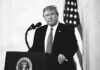 Trump Asked If He’d Accept Midterm Results Donald Trump at a podium with microphone and U.S. flag in background