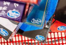 Hasbro Gaming board game boxes in a shopping cart