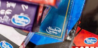 Hasbro Gaming board game boxes in a shopping cart