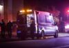Ambulance at night with paramedics attending a patient