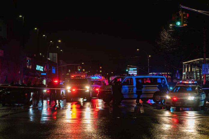 Nighttime police scene with flashing lights on a wet city street