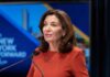 Republican TORCHES Dem Governor in CAGEY Debate Kathy Hochul speaking at a podium with microphones