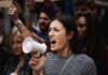 Woman with megaphone shouting at a protest