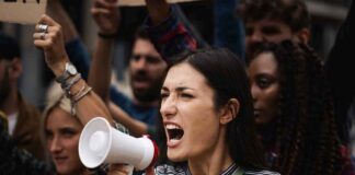 Woman with megaphone shouting at a protest