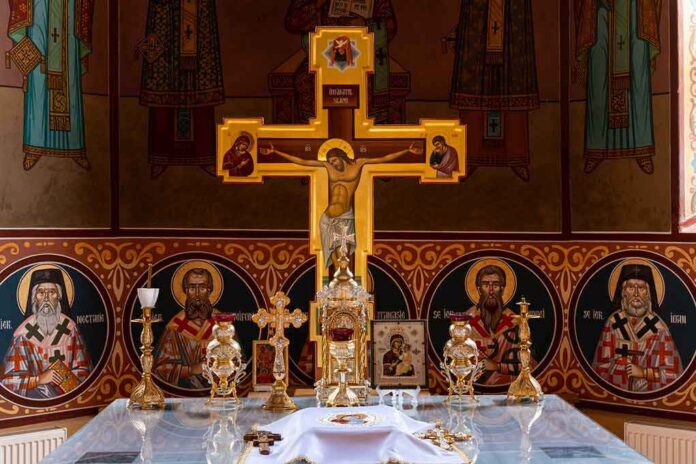 Orthodox church altar with large gilded cross and icons