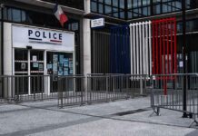 National Emergency Looms, Curfews Hit Hotspots Police station entrance with barriers and French flag colors