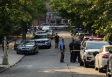 Officers Down AMBUSHED In Midnight Attack Police officers secure a residential street with patrol cars and yellow tape