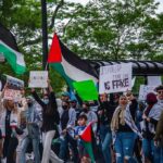 Muslims Change Chant From ‘Death to America’ to THIS! Wang Ying among protesters holding Palestinian flags and signs at a street demonstration