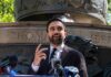 Zohran Mamdani speaking at an outdoor press conference