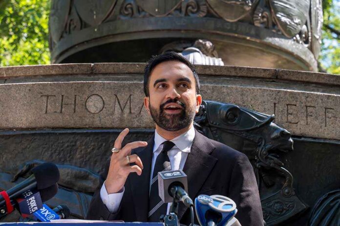 Zohran Mamdani speaking at an outdoor press conference