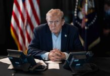 Trump Destroys GOP Senator in Late-Night Attack Donald Trump seated at a table between two desk phones