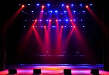 stage with red and blue spotlights shining onto an empty floor
