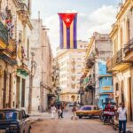 Cuban flag over colorful old Havana street