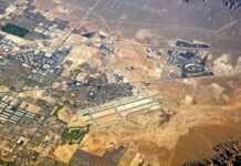 Packed Airport Terminal BOMBED – Hundreds Wounded Aerial view of desert city with airport and highways
