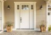 white front door with sidelights and planters