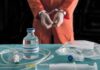 Lawyer Shares Christa Pike’s First Words After Botched Execution Handcuffed person in orange jumpsuit behind medical vials and IV equipment